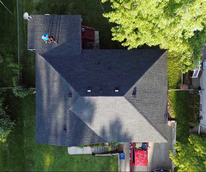 A professional roofer is installing ice and water layer on the roof near Muskego, WI