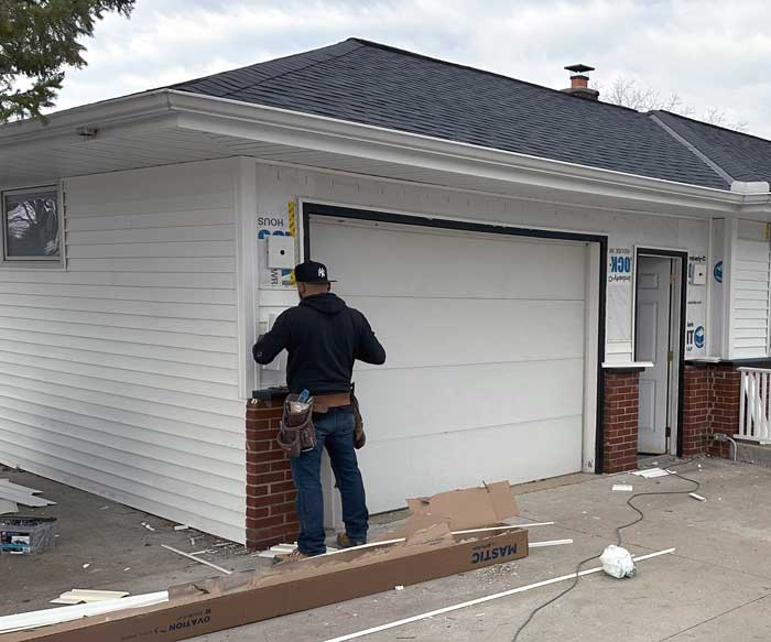 A professional from First Choice Roofing is installing new siding near Muskego, WI