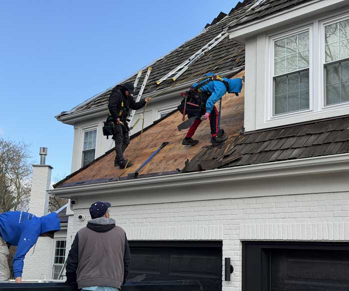 Professional roofing crew working on a roof replacement project near River Hills WI