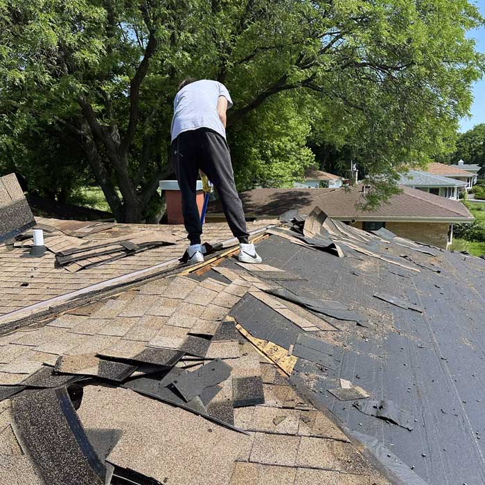 Roofing crew removing an old and installing a new roof near Menomonee Falls Wisconsin