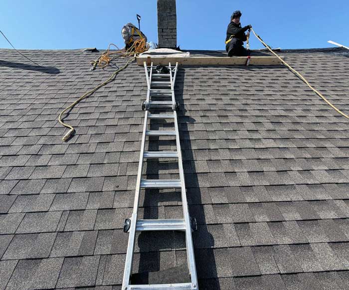 Crew completing a new roof installation on a home in Waukesha, Wisconsin