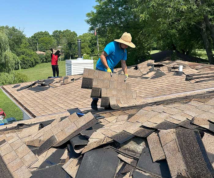 Roofing contractors removing old and installing a new roof on a home in New Berlin Wisconsin
